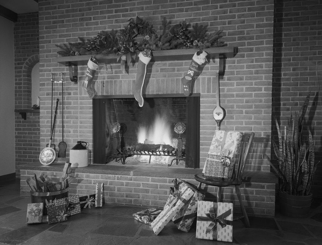 Detail of Stockings hung by fireplace and wrapped christmas presents by Anonymous