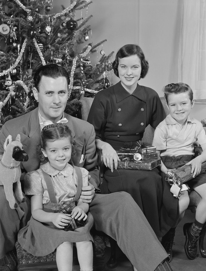 Detail of Family portrait by christmas tree by Anonymous