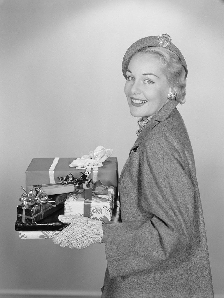 Detail of Smiling woman holding wrapped christmas presents by Anonymous