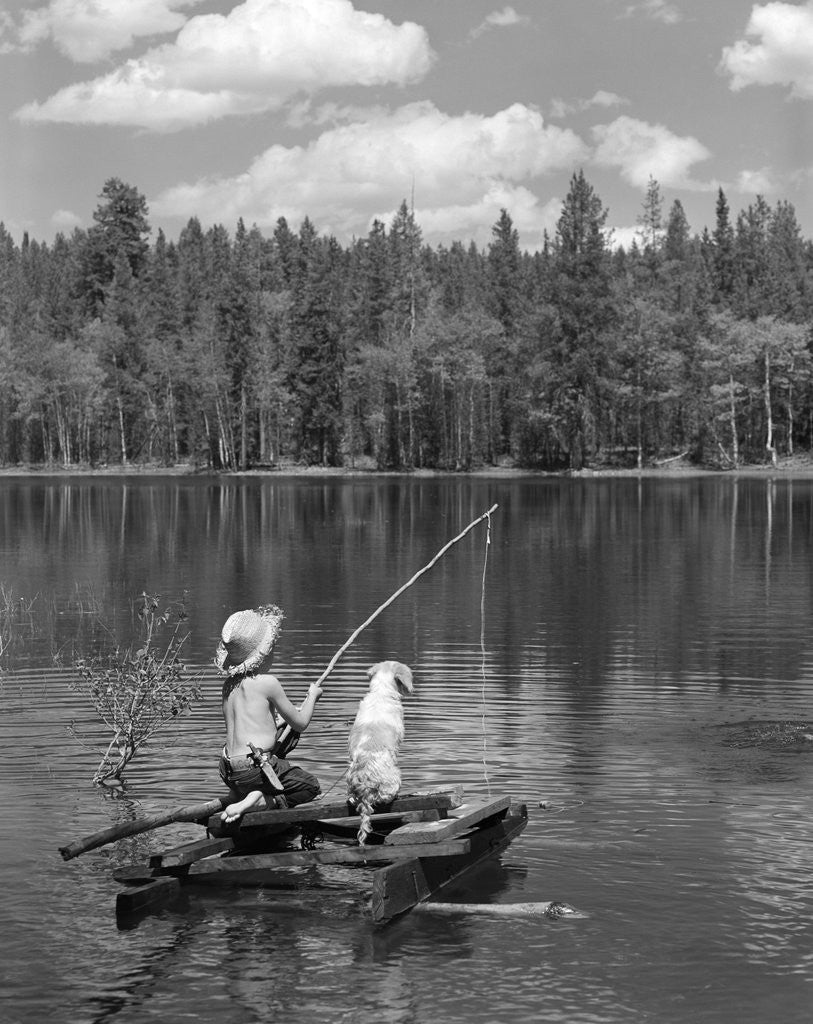 Detail of Boy huck finn style on homemade raft with dog fishing in lake by Anonymous