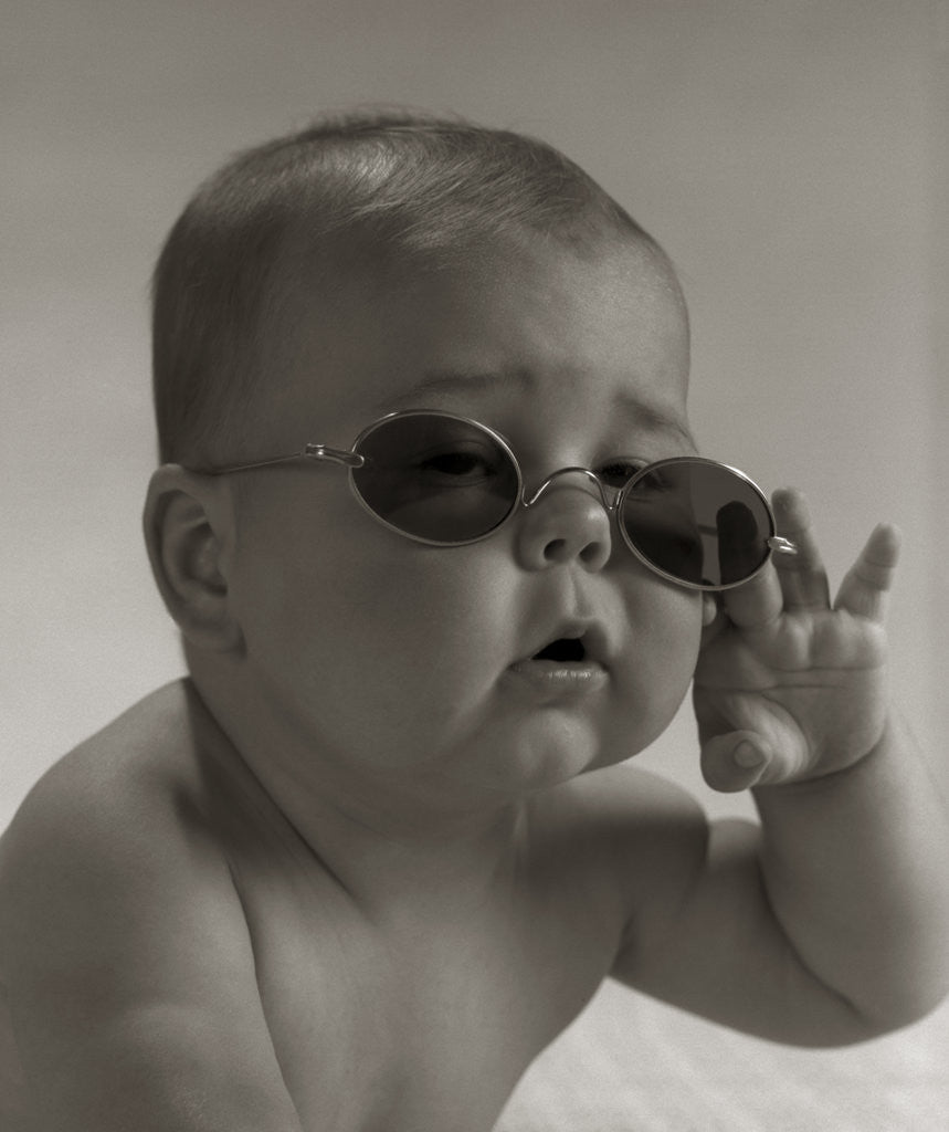 Baby wearing granny glasses sunglasses by Corbis