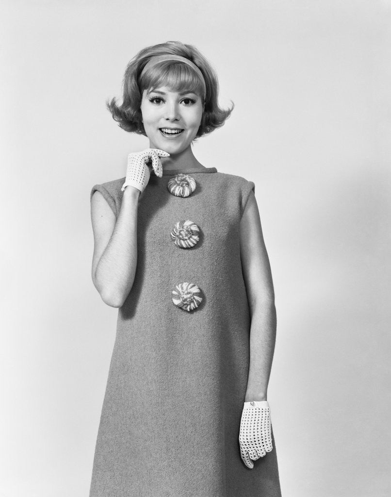 Detail of Smiling stylish young woman wearing sack dress gloves by Anonymous