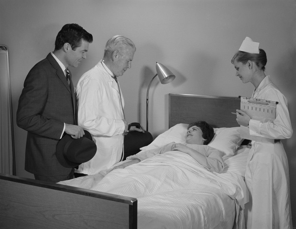 Detail of Doctor nurse husband talking with female patient in hospital bed by Anonymous
