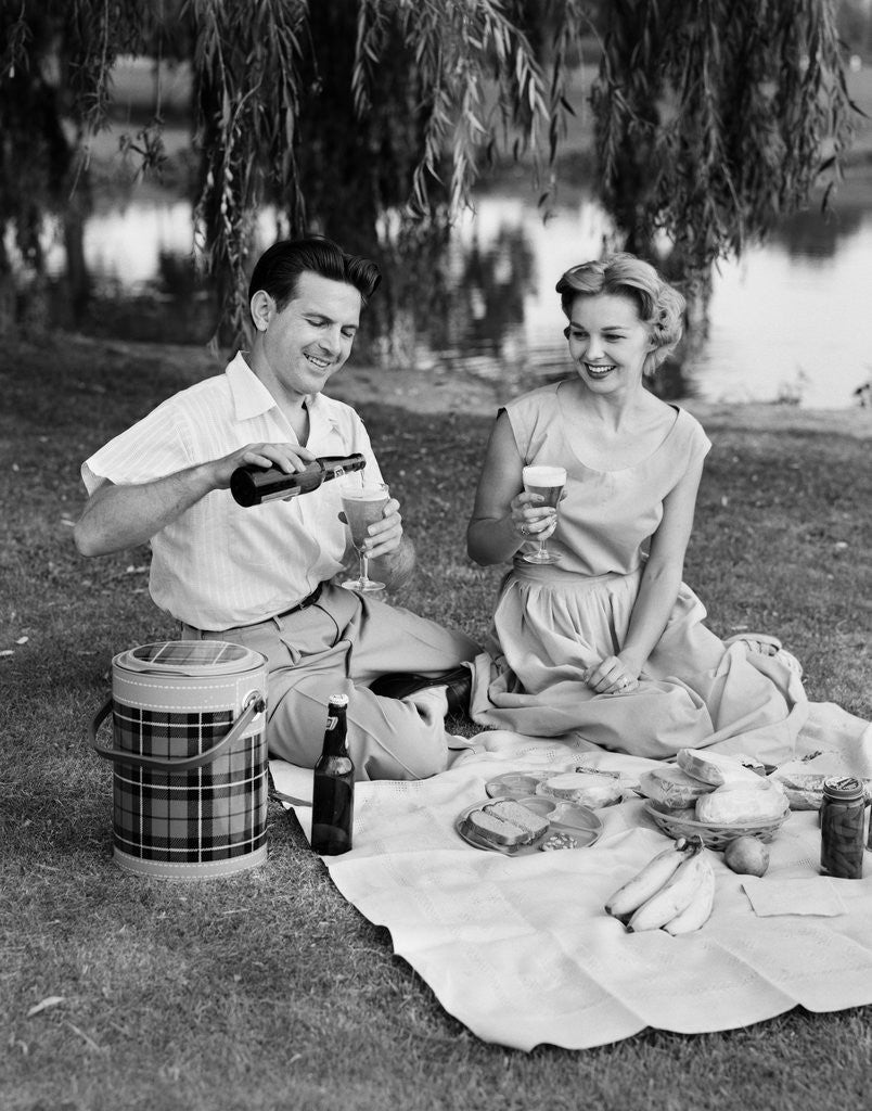Detail of Man woman couple having a summer picnic outdoors drinking beer by Anonymous