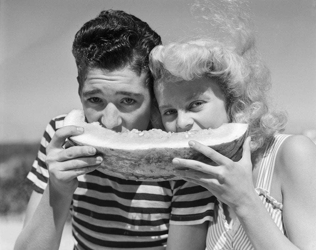 Detail of Teen age boy & girl eating slice watermelon by Anonymous