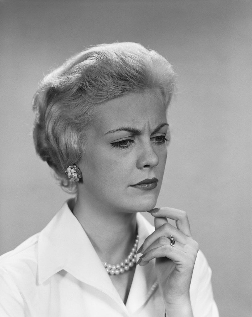 Detail of Blond woman pearl necklace worried concerned facial expression by Anonymous