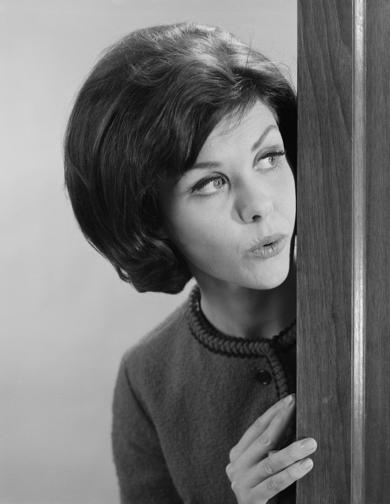 Detail of Brunette woman peeking around corner by Anonymous