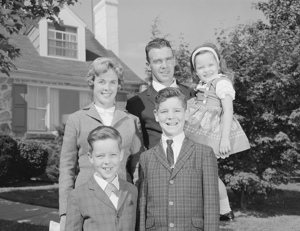 Detail of Family portrait father mother two sons and daughter in front of suburban house by Anonymous