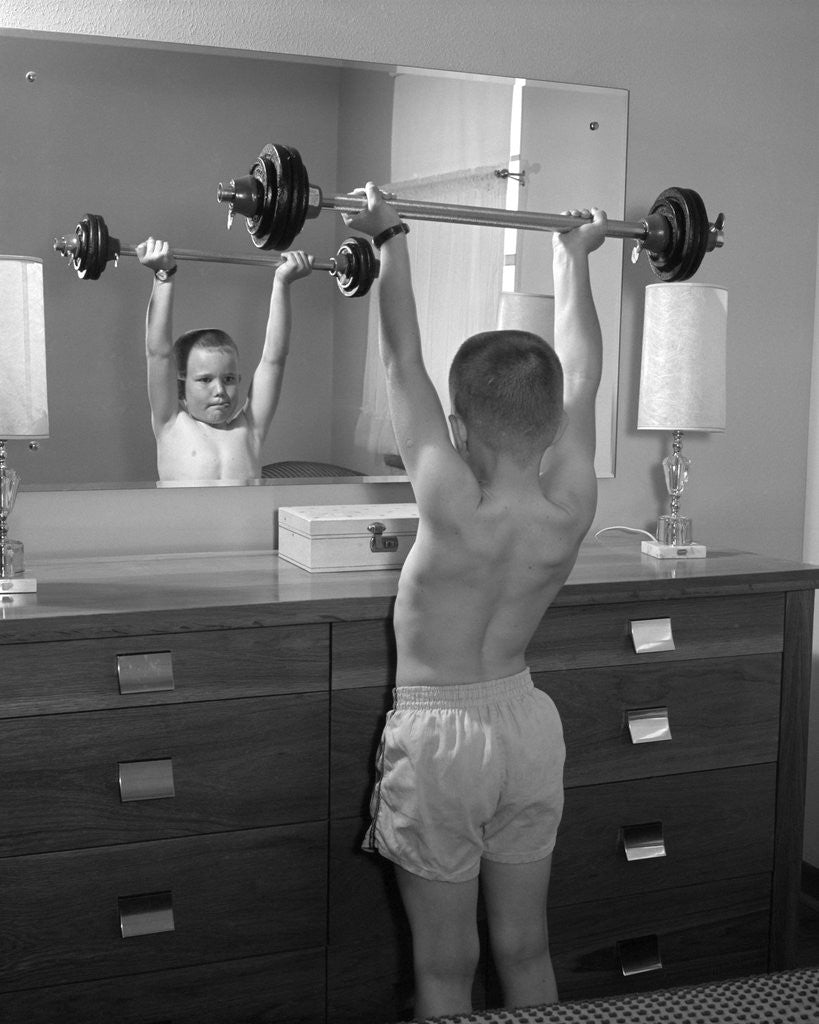 Detail of Boy exercising with dumbbell at mirror in bedroom by Anonymous