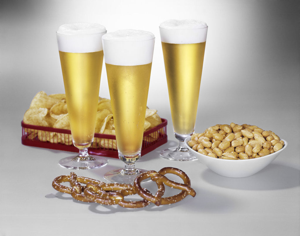Detail of Three pilsner glasses of beer pretzels peanuts potato chips by Anonymous