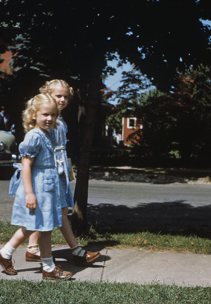 Detail of Two blond girls wearing blue dresses on the first day of school by Anonymous
