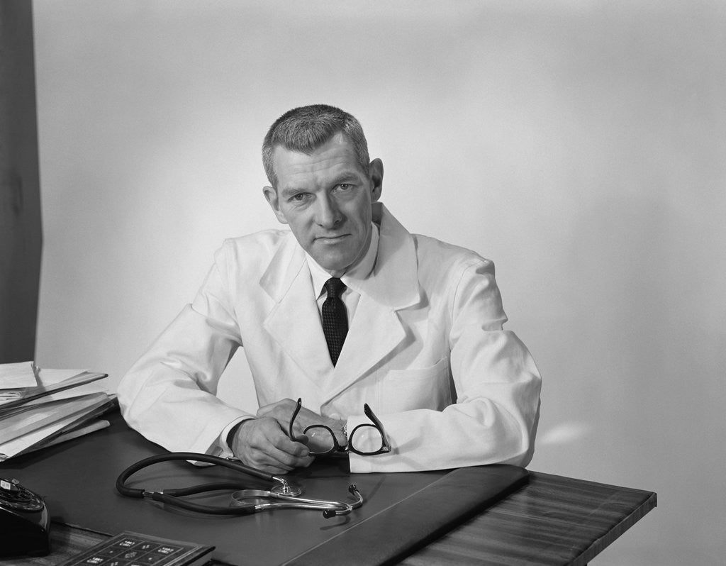 Detail of Portrait male doctor sitting at desk serious expression by Anonymous