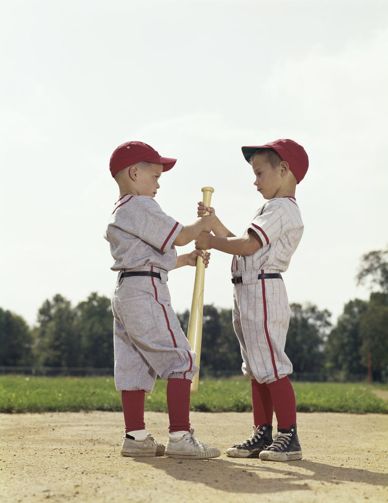 Detail of Two boys holding baseball bat little league uniforms by Anonymous