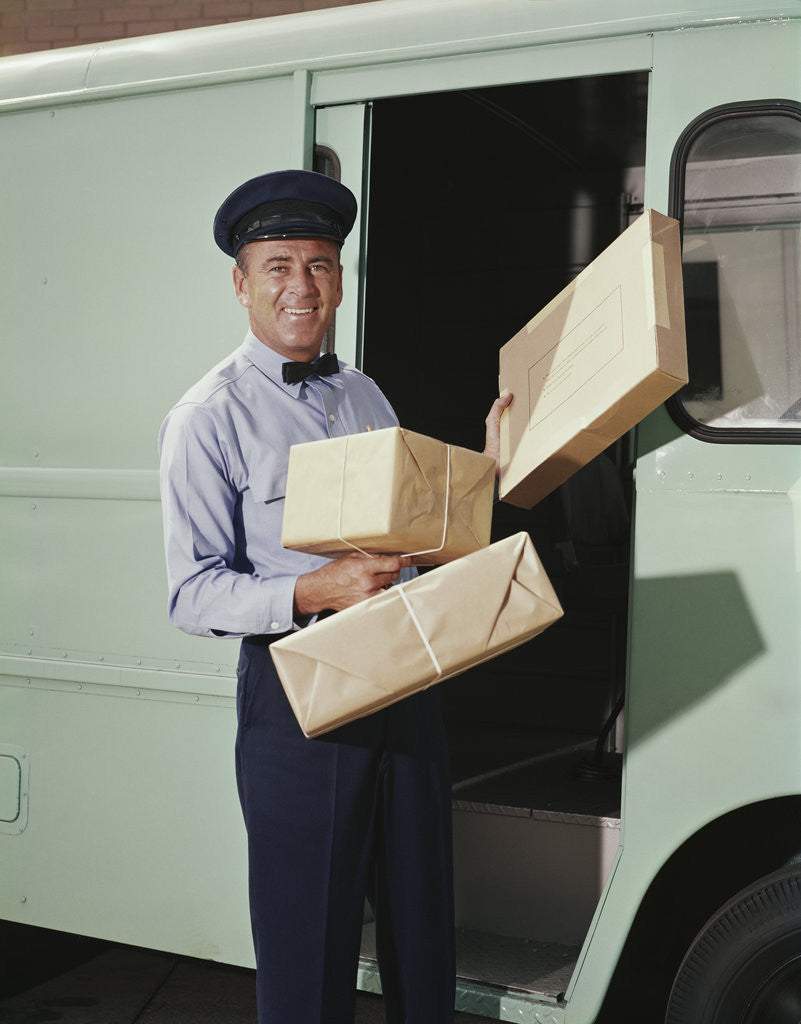 Detail of Delivery truck driver holding packages by Anonymous