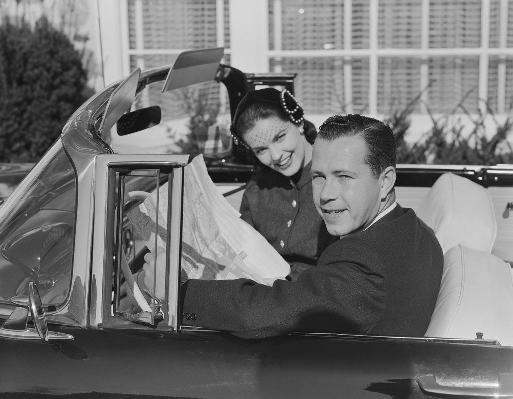 Detail of Husband wife man woman in automobile reading map by Anonymous