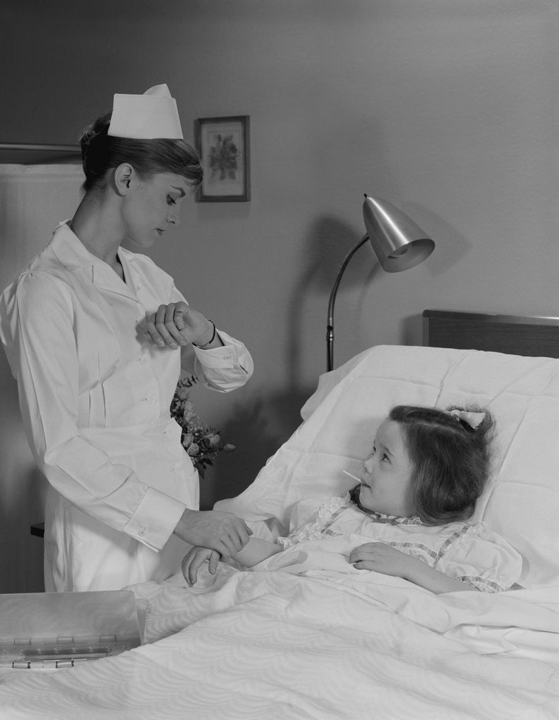 Detail of Woman nurse checking pulse taking temperature on little girl patient in hospital bed by Anonymous