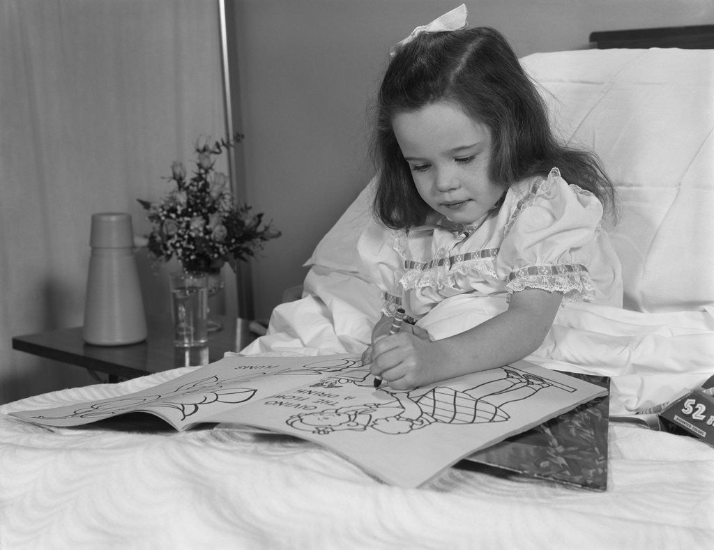 Detail of Little girl patient in hospital bed writing in coloring book by Anonymous