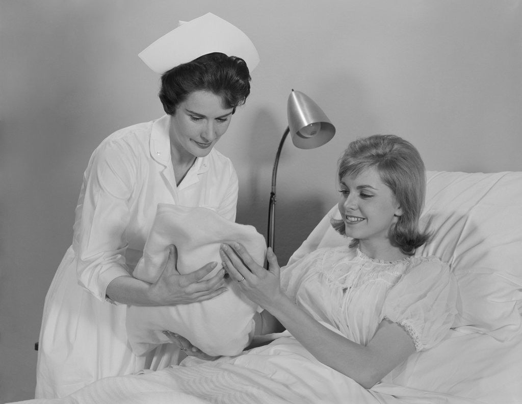 Detail of Woman nurse giving baby to smiling mother patient sitting in hospital bed by Anonymous