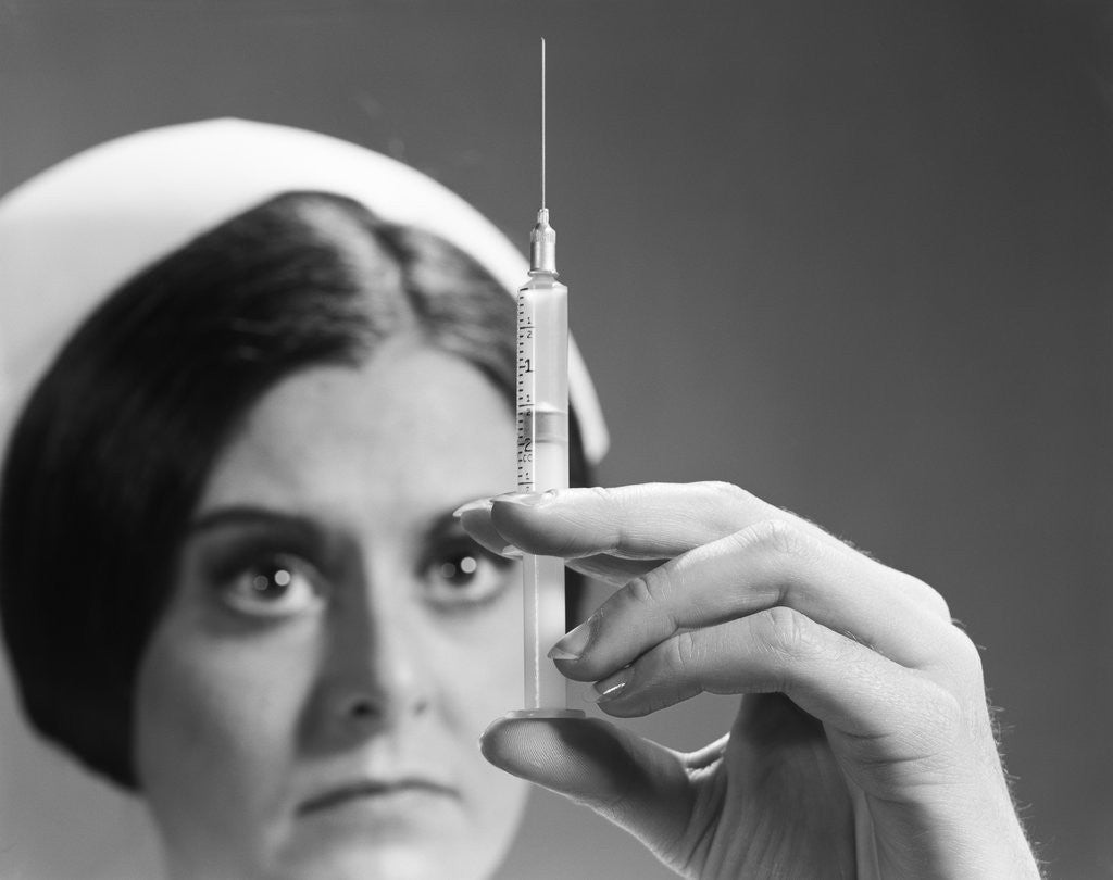 Detail of Nurse adjusting dosage injection hypodermic needle by Corbis