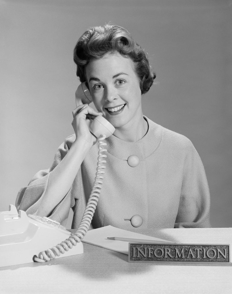 Detail of Smiling woman secretary talking on telephone information desk by Anonymous