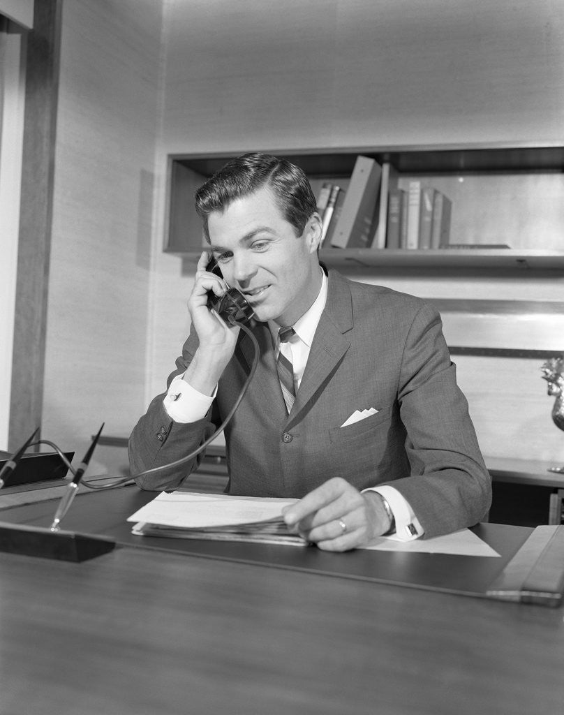 Detail of Businessman executive at desk talking on telephone by Anonymous