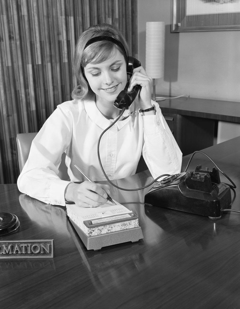 Detail of Secretary receptionist talking on telephone writing into desk calendar by Anonymous