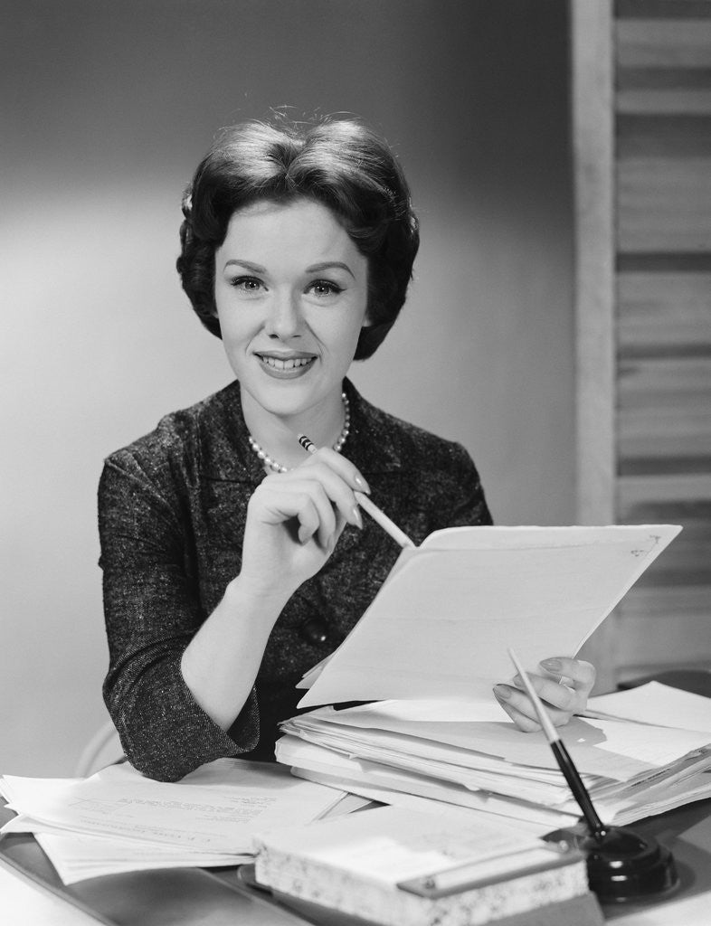 Detail of Portrait smiling executive woman holding files papers by Anonymous