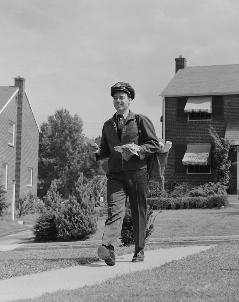 Detail of Postal mailman walking suburban street wearing uniform delivering mail by Anonymous