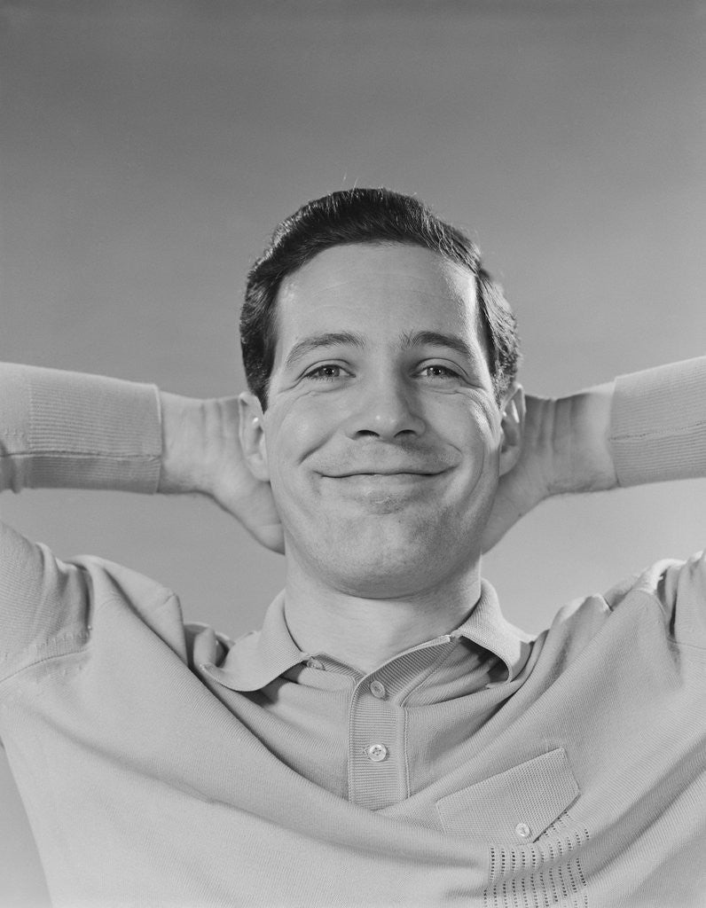 Detail of Man smiling relaxing with hands behind head by Anonymous
