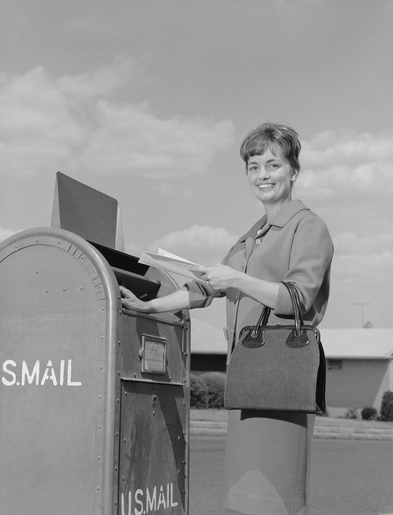 Detail of Smiling woman dropping letters in postal mail box by Anonymous