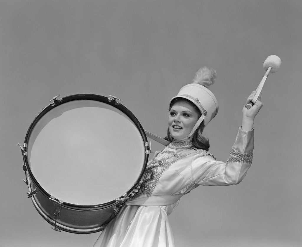 Detail of Smiling young woman band uniform carrying playing big drum by Anonymous