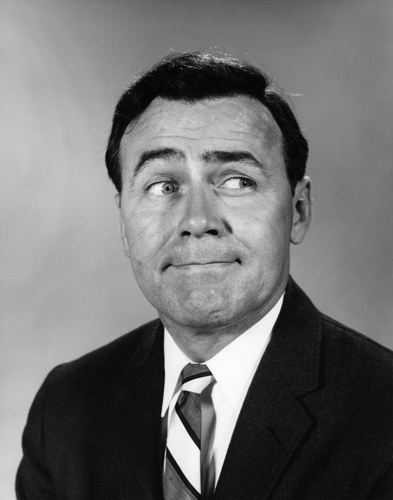 Detail of Businessman making funny face looking to the side by Anonymous