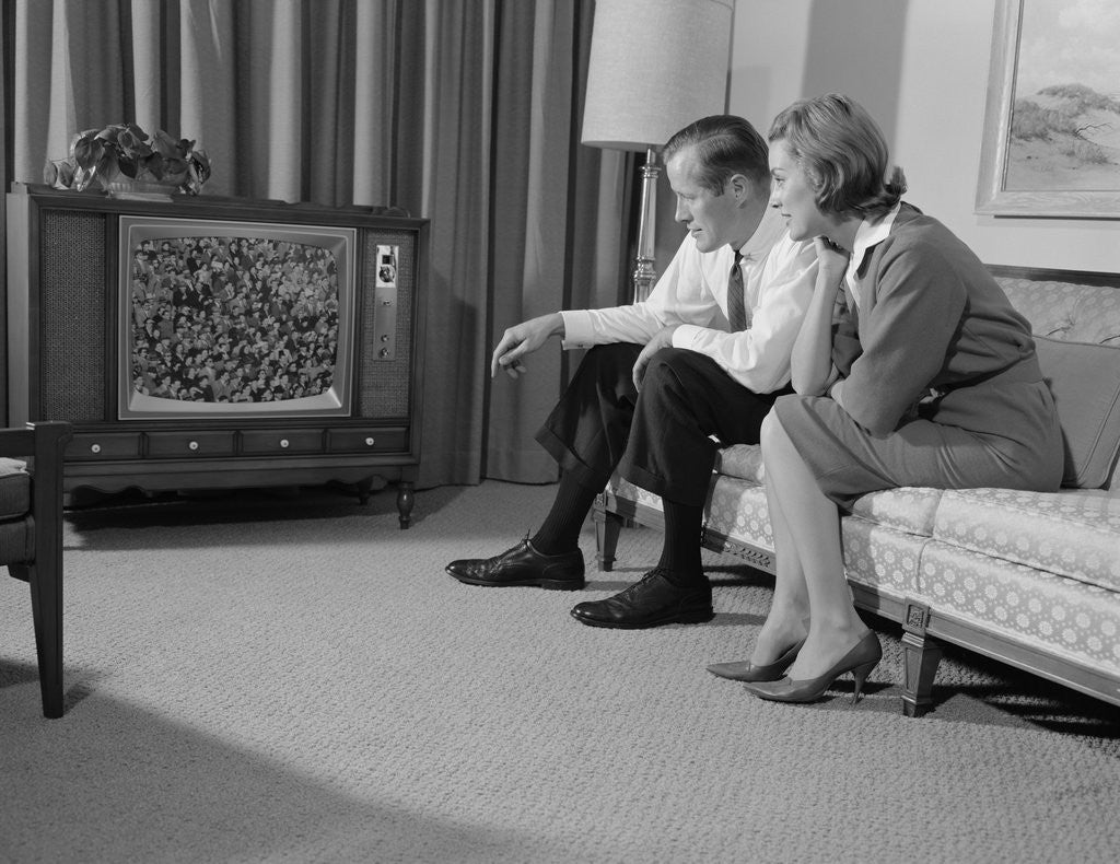 Detail of Couple man woman sitting on couch watching television by Anonymous