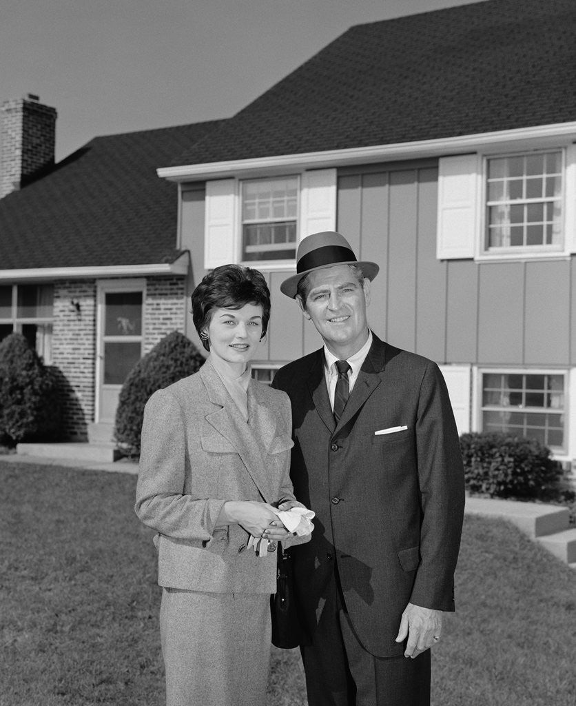 Detail of Couple smiling man and woman standing before suburban house by Anonymous