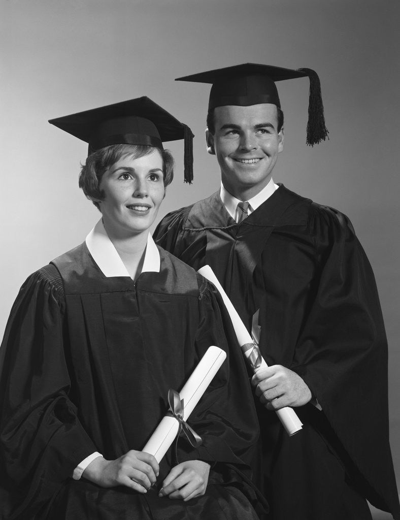 Detail of Portrait couple man woman in graduation robes holding diplomas smiling by Anonymous