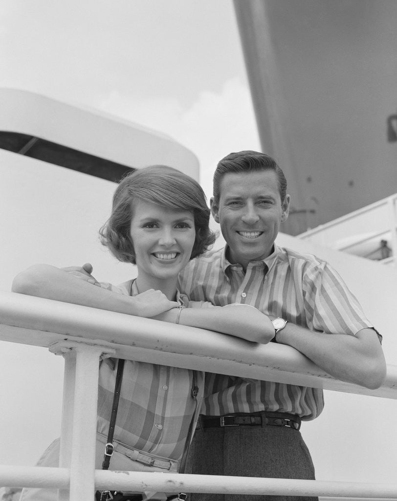 Detail of Portrait smiling couple standing by shipboard rail by Anonymous