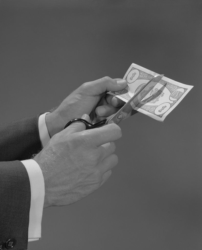 Detail of Male hands with scissors cutting dollar bill in half by Anonymous