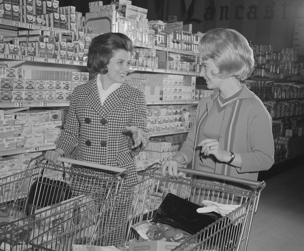 Detail of Two women talking shopping supermarket by Corbis