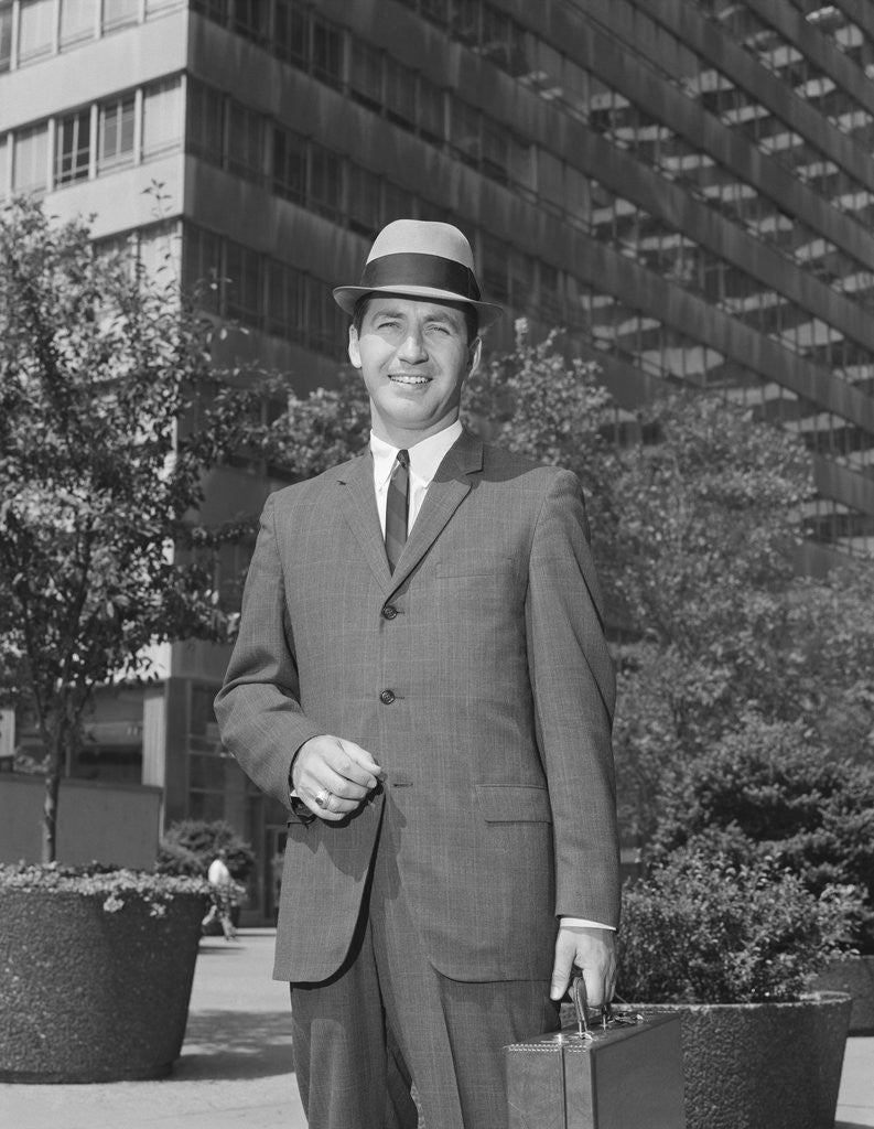 Detail of Portrait businessman wearing hat suit holding briefcase by Anonymous