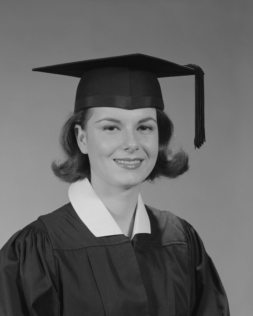Detail of Portrait smiling young woman wearing graduation cap and gown by Corbis