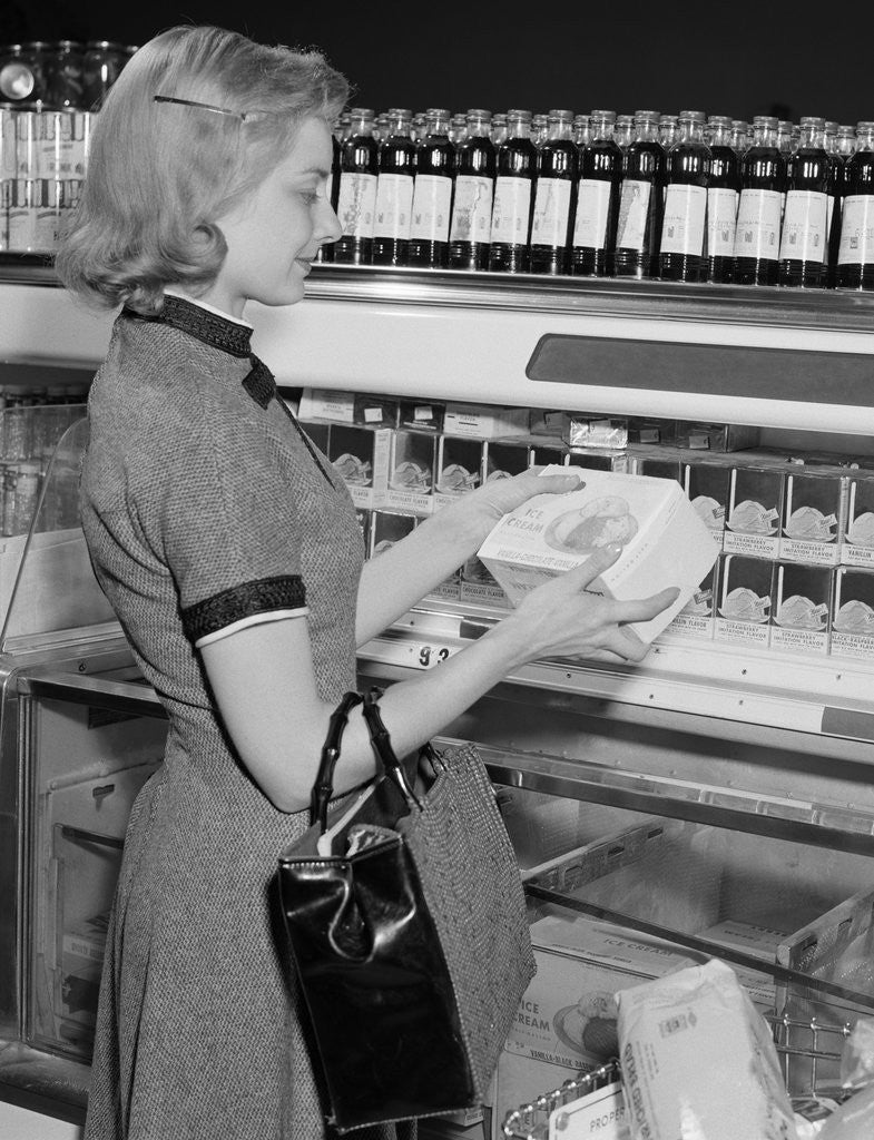 Detail of Blond woman selecting ice cream frozen food section supermarket by Anonymous