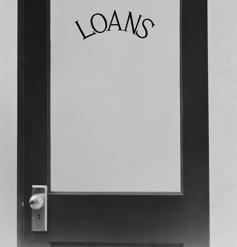 Detail of Office door glass panel with sign loans by Anonymous