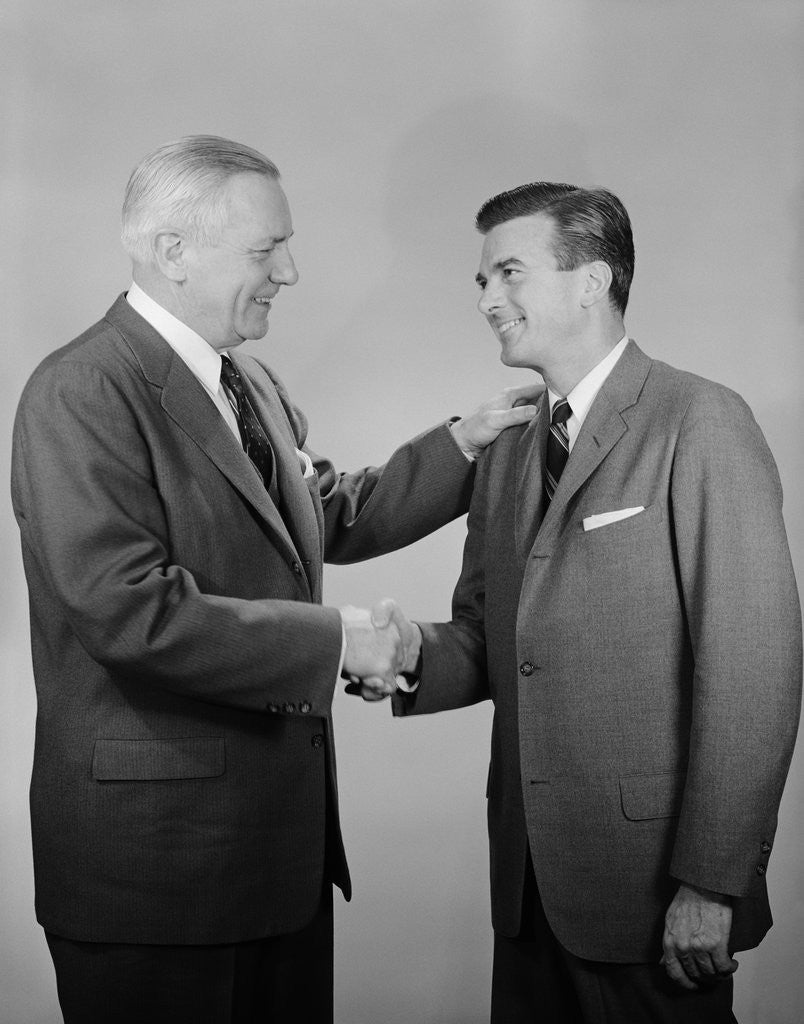 Detail of Older and younger business men shaking hands by Anonymous