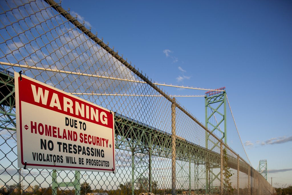 Detail of No trespassing sign on fence by the Ambassador Bridge by Anonymous