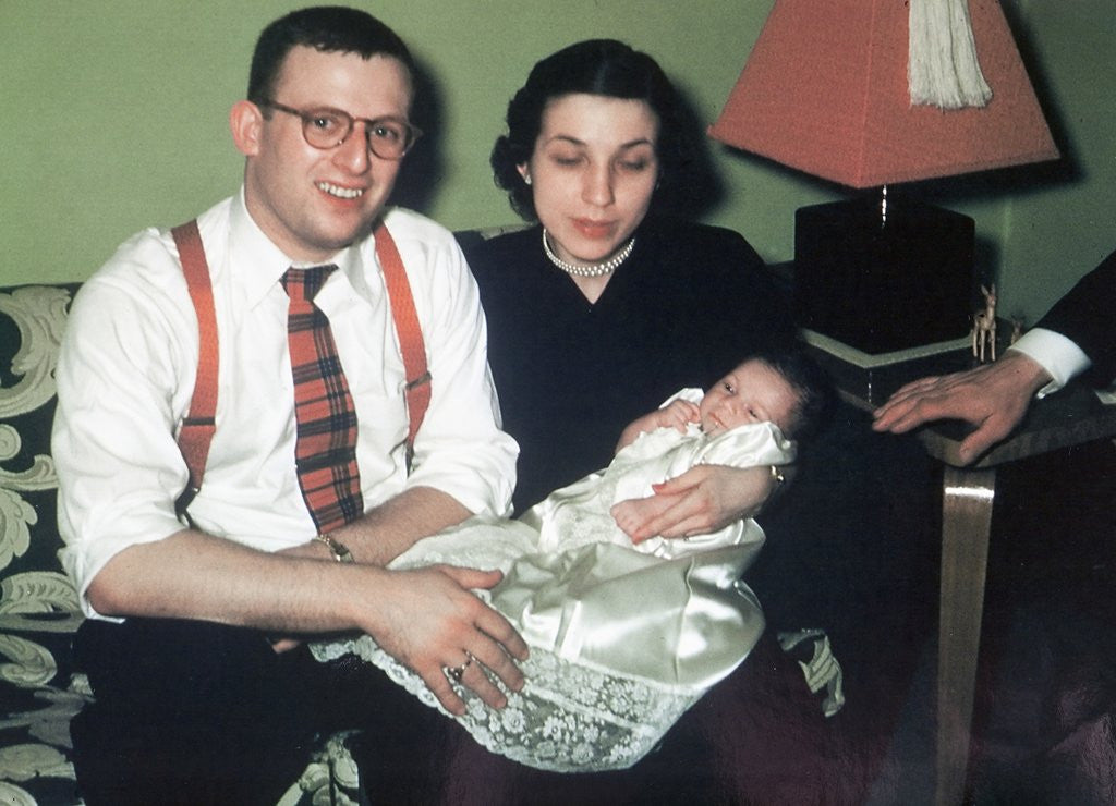 Detail of Young couple holding baby boy in christening gown, ca. 1952 by Anonymous