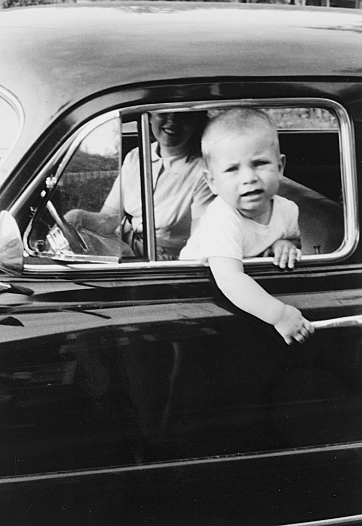 Detail of Young boy hangs out of driver's side car window, ca. 1954 by Anonymous