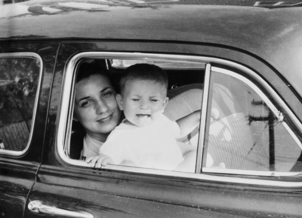 Detail of Mother holds crying son in her lap in car, ca. 1954 by Anonymous
