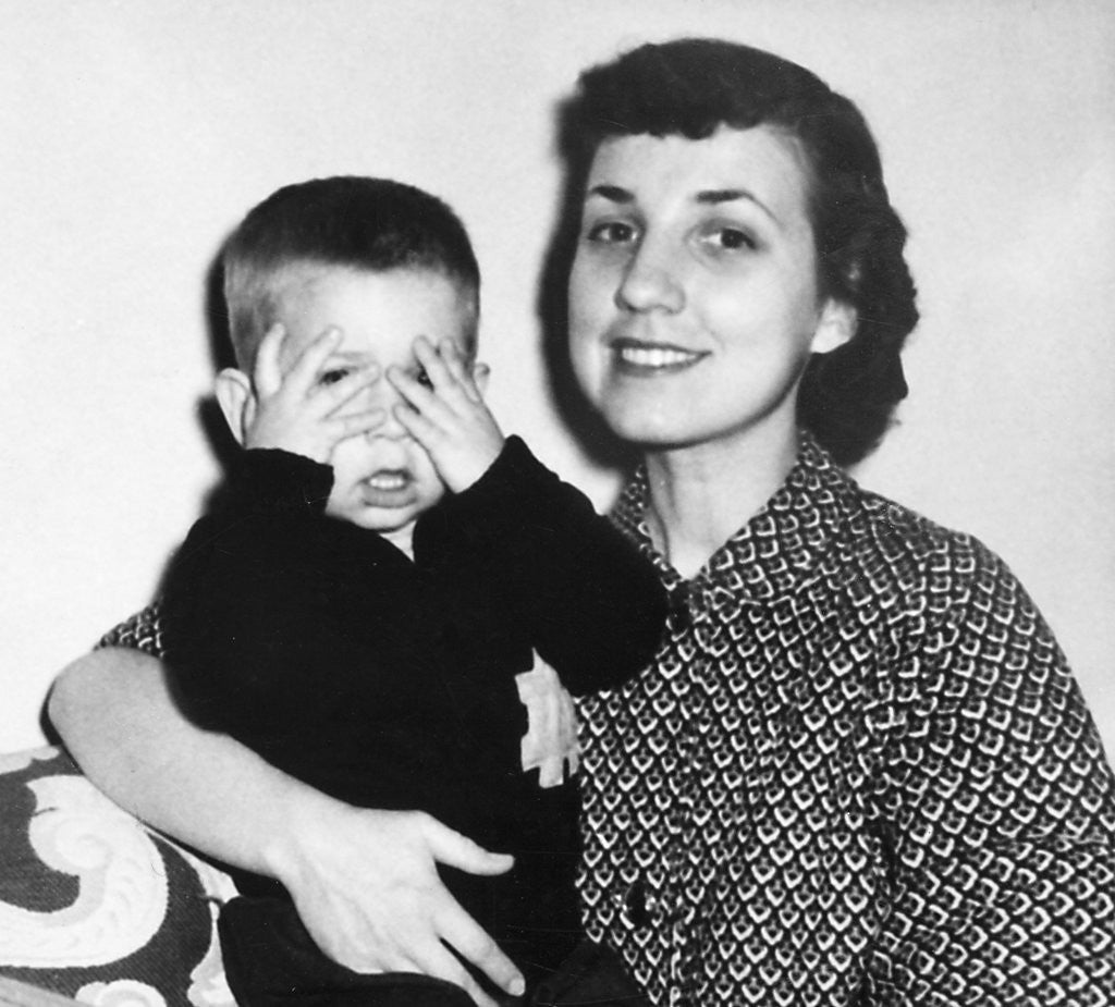 Detail of Mother holding son playing peek-a-boo, ca. 1955 by Anonymous