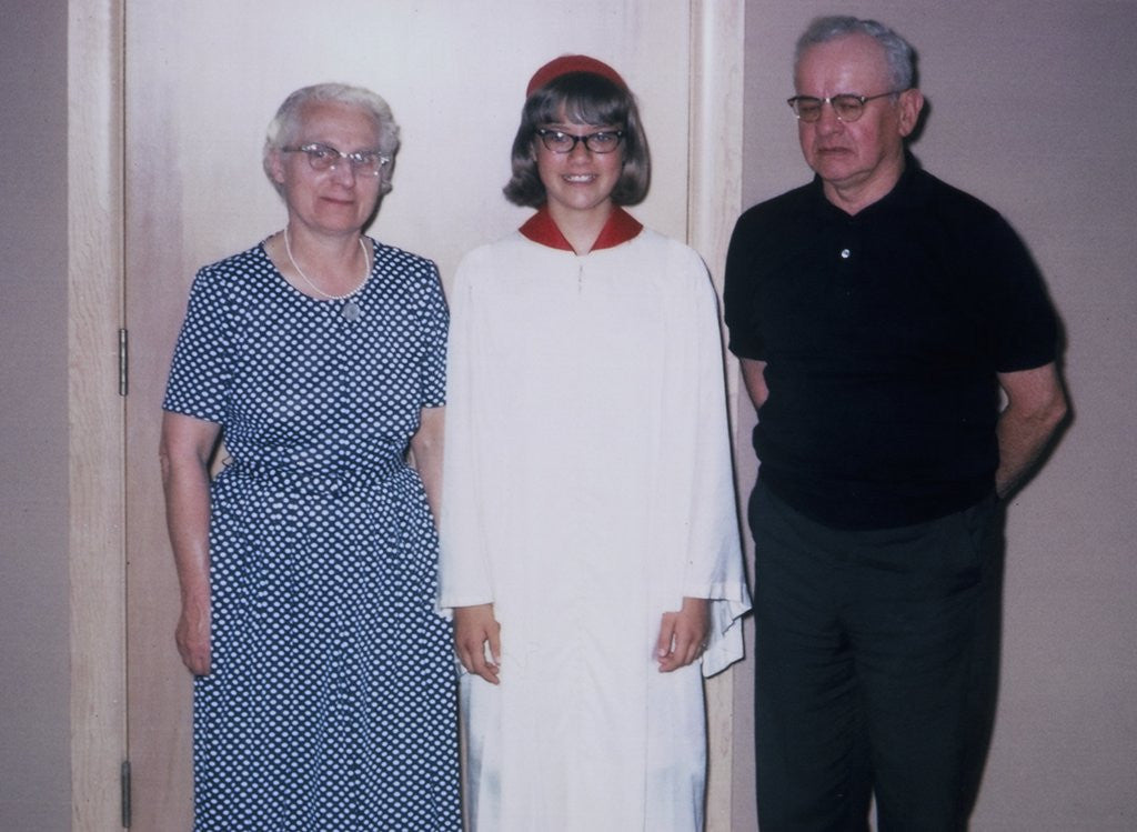 Grade school graduate with her grandparents, ca. 1966 by Corbis