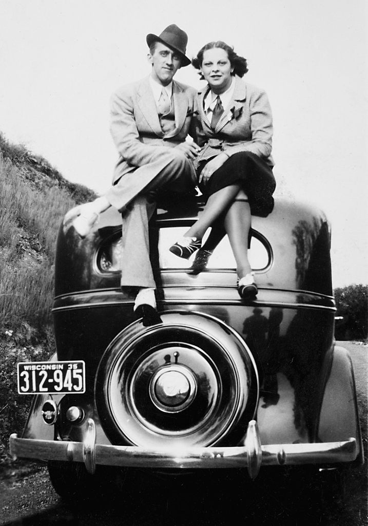 Detail of Couple proudly sits on their new car, ca. 1935 by Anonymous